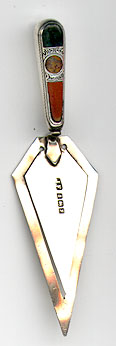This bookmark was made in Birmingham, England. It is marked with the hallmarks for that city and the date mark for 1923. It is in the shape of a trowel with  multi-colored agates.