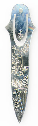 This bookmark was made in China by an unknown manufacturer. It is marked only silver. It has a scored picture of flowers The date is 1970 - 1980.