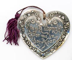 This bookmark was made in the US by an unknown manufacturer. It is marked only sterling. It is a heavy figural heart with flowers around the outside blade. The inner blade has the words, "Keep a thought for me in your heart." The date is 1890 - 1900.