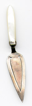This bookmark was made in the US by Webster Company. It is marked with the manufacturers hallmark. It is in the shape of a trowel with a mother of pearl handle. The date is 1920 - 1930.