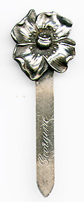 This bookmark was made in the US by Unger Brothers. It is marked with the makers hallmark of a U intertwined with a B. It is a figural flower and was sold in the 1904 Unger Brothers catalog. 