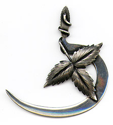 This bookmark was made in the US by C. Klank and Sons. It is marked sterling with the manufacturers hallmark. It is a beautiful figural piece where the top blade is three strawberry leaves and the bottom is either a sickle or a flattened snake. The date is 1890 - 1900.