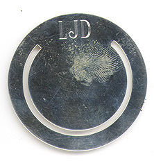 This bookmark was made in the US by Lenore Doskow. It is marked Doskow 925. It is a simple round bookmark very similar to one that Tiffany makes. The date is 1980 - 1990.