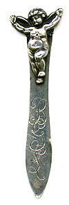 This bookmark was made in the US by an unknown manufacturer. It is marked sterling. The top has a figural cherub with arms and wings outstreached. The date is 1900 - 1910.