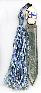This bookmark was made in Helsinki, Finland by Karl A Lind. It is marked with many hallmarks, each with a different meaning. The 813H means it is .830 silver and the A6 is a date mark for 1930. The top is an enamel oval with a picture of the Finnish flag. It has a light blue silk tassel.