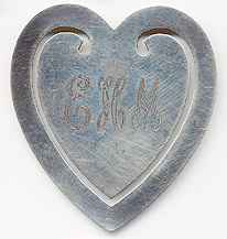 This bookmark was made in the US by R. Blackington for Tiffany. It is marked with the hallmarks of both manufacturers. It is in the shape of a heart. The back is inscribed Love at Christmas 1976.