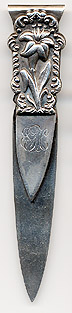 This bookmark was made in the US by S. Cottle Co. from New York. It is marked on the back with the manufacturers hallmark. The top is a figural flower. Date is 1890 - 1900
