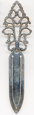This bookmark was made in by an unknown manufacturer possibly in Germany or Austria. It is marked with a hallmark of a horse with the letters SC above it. The top has many cut outs in it's design. Date is 1950 - 1960.