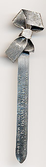  This bookmark was made in the US by Gorham. It is marked with Gorham, the makers hallmark, and Sterling. It is a figural of a ribbon tied in a bow. The front says, 1000th Performance Chas. Fohmans' Stock Co. "Men & Women" Broad St. Theatre Phila March 28'92.  