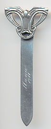  This bookmark was made in the US by Unger Brothers. It is marked with the manufacturers hallmark of the intertwined U and B. The top is an art deco design and the front is inscribed Anna 1911.  