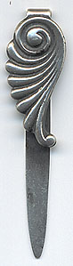 This bookmark was made in the US by Dominick and Haff, Inc. between 1889 and 1910. It is marked with the manufacturers hallmark, sterling and the number 18. The smaller top blade has an art nouveau design .