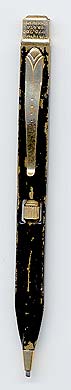  This bookmark was made in the US by an unknown manufacturer. It is marked with patent numbers 975,788 and 98,476. It is a bookmark/mechanical pencil that is flat so it can be clipped to a page in a book. Turning the wheel in the center raises or lowers the led.    
