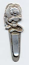  This bookmark was made in Mexico. It is marked Janna Sterling Mexico on the back. The top is a figural lion reading a book. The date is 1970 - 1980.    