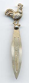 This bookmark was made in England. It is hallmarked for Birmingham. The top is a figural rooster. The date is 1927.     