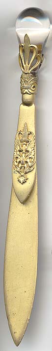  This bookmark was possibly made in France by an unknown manufacturer. It is unmarked and is gold dore over brass. The top has a large crystal. The date is 1900 - 1920.     