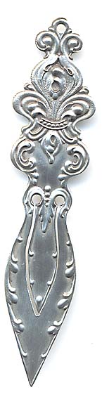  This bookmark was made in the US by Woodside Serling Co. It is marked on the back with the makers hallmark of a wreath surrounding the letter W. It is an art nouveau piece with a fancy fleur-de-lis making up the top.  