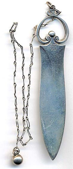  This bookmark was made in Denmark by Georg Jensen. It is marked with the makers hallmark and 925 Sterling Denmark. Attached to the top of this single blade bookmark is a long change with a ball at the end. The date is 1920 - 1940.   