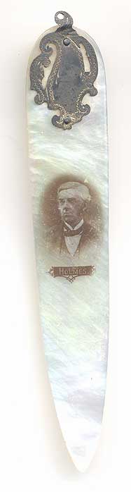  This bookmark was made in the US by an unknown manufacturer. It is made of mother-of-pearl and silver and had a red silk tassel on top. There is a photo of Oliver Wendell Holmes, Sr. on the blade. It was most likely used as a letter opener as well. 
