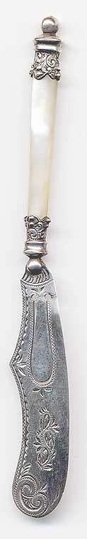  This bookmark was made in England. It has the standard English hallmarks and a manufacturers mark. It has a mother of pearl handle and is in the shape of a butter knife. The date is 1898.   