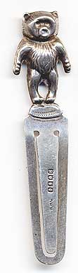  This bookmark was made in Glasgow, Scotland. It is marked W.H.C and the hallmarks for 1929. The top is a figural teddy bear with arms akimbo.   