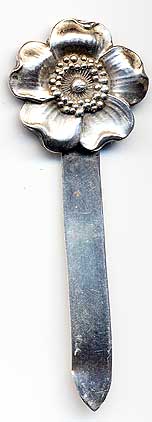  This bookmark was made in the US by Unger Brothers. It is marked with the manufacturers hallmark. The top is a figural flower. It was the January flower in a set of 12 from the 1904 catalog.   
