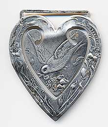  This bookmark was made in the US by Webster. It is marked only sterling. Originally, it had a large silk ribbon with a tassel at the end. It is heart shaped with a picture of a dove. The date is 1913.   