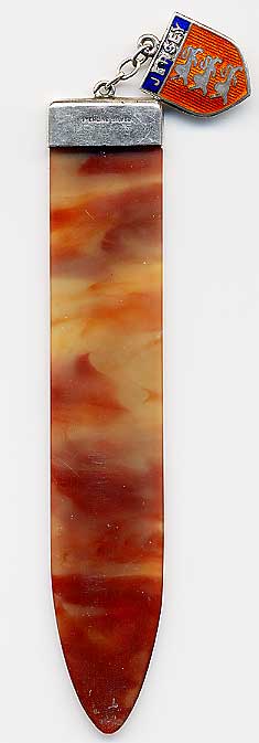  This bookmark was made in Europe. It is marked sterling silver and is made of celluloid or bakelite. The top has an enamel shield that says Jersey at the top. The date is 1910 - 1930.  