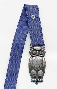  This bookmark was made in Norway or Denmark. It is marked 925S and has an unidentified hallmark. It is a figural owl with a blue ribbon.   