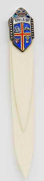  This bookmark was made in Europe. It is marked 935 and has an unidentified hallmark. It is has celluloid (french ivory) blades and a silver and enamel shield on top. The date is 1920 - 1930.  