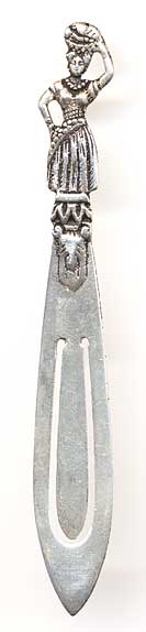 This bookmark is of unknown origin. It has an unknown hallmark on the back. The top is a detailed figural woman holding a basket on her head. The date is 1920 - 1950.