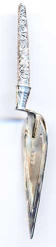  This bookmark was made in Birmingham, England by Adie and Lovekin. It is in the shape of a trowel. The date is 1921. 