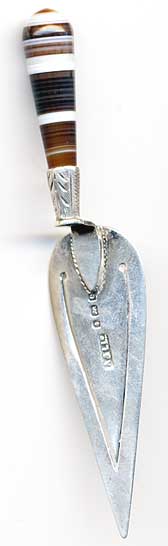  This bookmark was made in Birmingham, England by Adie and Lovekin. It is in the shape of a trowel with a banded agate handle. The date is 1904. 