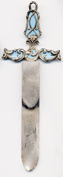 This bookmark is made in the US by an unknown manufacturer. It is marked sterling on the back and is in the shape of a fancy cross with light blue enamel. The date is 1900 - 1910.