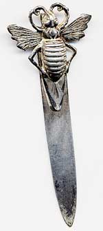 This bookmark is made in the US by an unknown manufacturer. It is marked sterling on the back. The top is a figural beetle.  The date is 1910 - 1930.