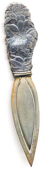  This bookmark is made in the US by Webster Co. It is marked sterling on the back. The top has a picture of a flower. The date is 1913 and was sold as a letter opener and as part of a novelty set.  