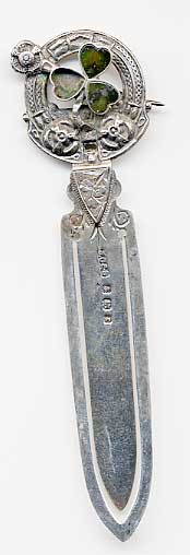  This bookmark is made in Birmingham, England. The manufacturer is JC&amp;S. The top is an intricate design including a shamrock with green agate stones.  The date is 1906.  