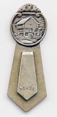  This bookmark is made in Norway. It is marked 830S and Norge. The top is a picture of a raised house and a tree.  The date is 1930 - 1950.  