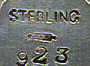 This bookmark is a William B. Kerr & Co. piece. It has the American Beauty mark and is stamped 923, probably a catalog number. It was made around the turn of the 20th century.