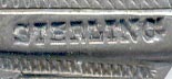 This bookmark was made in the US by an unknown manufacturer. It is only marked Sterling. The top blade has the initials E.O.J. The date is probably 1900 - 1910.