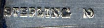This bookmark was made in the US by an unknown manufacturer. It is marked Sterling 2. The front top is inscribed "Jamar". The date is 1900 - 1910.