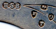  This bookmark was made in London, England. It is marked with HSB, the manufacturer, the hallmarks for London and the year 1889, and Houghton & Gunn 162 New Bond St. W. It is a figural Man in the Moon with a face on both sides.   