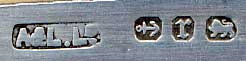 This bookmark was made in England by Adie and Lovekin. It is a figural sword or knife and has hallmarks for Birmingham. The date is 1891.