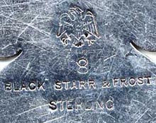 This bookmark was made in the US by Black, Starr & Frost and is marked as such with their hallmark of eagle with spread wings. The bookmark is in the shape of a spade and is inscribed 1830 H.P. 1911. This is possibly masonic. The date is 1911.