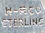 This bookmark was made in the US by H-RCo. It is marked H-RCO Sterling on the back. The top is a blue, green and yellow enamel paradise fish. The date is 1900 - 1910.
