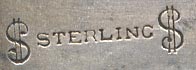 This bookmark was made in the US by Watson Company. It is marked with two "$" signs with sterling inbetween. The top is the head of a bearded man.