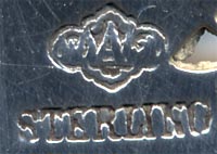 This bookmark was made in the US by Alvin Corp. It is marked with the makers mark on the back. The top is an anchor, heart and cross symbolizing faith, hope and charity.  