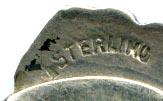 This bookmark was made in the US by F.A. Hermann Co. It is marked sterling and has half of a hallmark on the top back. The top is an enamel pansy flower in purple and yellow. 