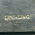 This bookmark was made in the US by an unknown manufacturer. It is marked sterling on the back. The top has grasshopper in a different metal, possibly gold.