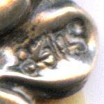 This bookmark was made in either Denmark or Norway. It  has a sterling rose on top of two celluloid blades and is marked 830s.