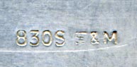 This bookmark was made in Denmark by Eiler & Marløe of Copenhagen. The back is hallmarked 830s and E & M. The top is a detailed bust of Hans Christian Andersen surrounded by a shield of deep blue enamel.